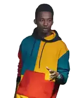 a young man wearing a colorful hoodie is pointing at something