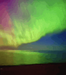 a painting of a colorful aurora borealis over a body of water