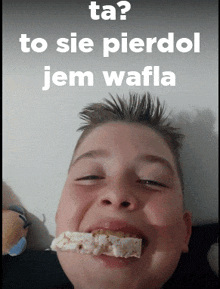 a young boy with a piece of food in his mouth and the words ta to sie pierdol jem wafla