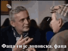 two men are having a conversation in a foreign language with the caption " faca ti je lopovska "