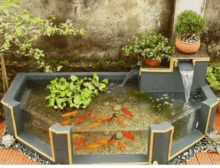 a small fish tank with a waterfall and plants in it .