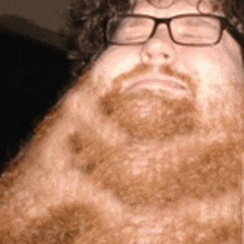 a man with glasses and a beard has a very long neck