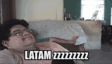 a man laying on a couch with the words latam zzzzzzz on the bottom of his shirt