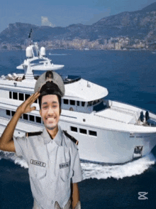 a man in a military uniform with the name lewis on his shirt salutes in front of a large white yacht