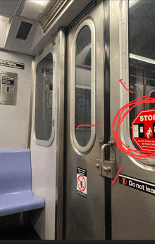 a subway car with a red circle around the door that says stop