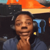 a man wearing headphones is smiling in front of a sign that says captain morgan