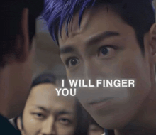 a man with purple hair has the words i will finger you on his face