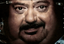 a close up of a man with a beard and mustache