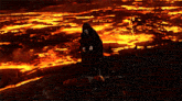 a man in a black cape stands in front of a lava lake