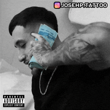 a man holding a stack of money with a parental advisory on the cover