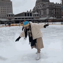 a woman is ice skating in front of a building that has a sign that says ' g & t ' on it