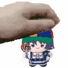 a hand is holding a stuffed doll with a lollipop in its hand .