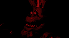 a cartoon character with red eyes and teeth is standing in the dark