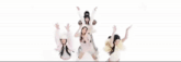 a group of young women are posing for a picture and one of them is wearing a furry hat