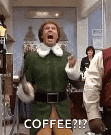 a man in a green elf costume is screaming with his mouth open .