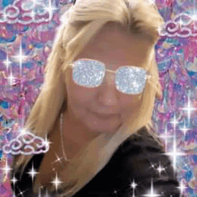 a woman wearing sunglasses and a necklace is surrounded by sparkles and clouds .