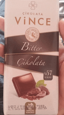 a person is holding a bar of bitter chocolate from vince