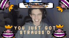 a boy is smiling in front of a screen that says you just got strauss d