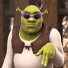 shrek from shrek is wearing sunglasses and making a hand gesture .