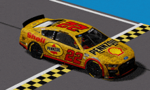 a yellow pennzoil race car with the number 22 on it