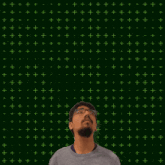 a man looking up at the number 16 with stars coming out of it