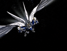 a blue and white robot with wings is flying through the air .