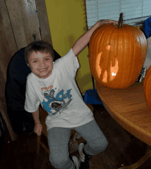 a young boy wearing a white shirt that says pirates on it