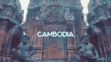 a statue in front of a building with the word cambodia on it