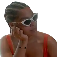 a woman wearing sunglasses and a bracelet holds her hand to her chin