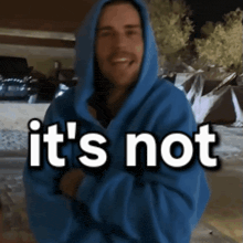 a man wearing a blue hoodie with the words it 's not written on it
