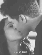 a man and a woman are kissing in a black and white photo and the woman is saying `` i miss this '' .