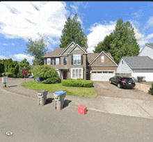 a stop sign in front of a house with a car parked in the driveway