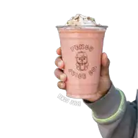a person is holding a smoothie that says penguin juice co.