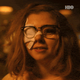 a woman wearing glasses has a bandage on her eye and a hbo logo on the bottom