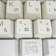 a close up of a keyboard with a foreign language on the keys