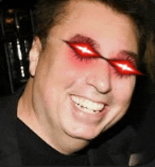 a man wearing sunglasses with red eyes is smiling and looking at the camera .