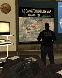 a police officer stands in front of a map that says ls gang formation map march 24