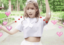 a girl in a crop top and white skirt is surrounded by pink hearts and stars