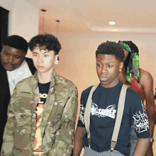 a man wearing a shirt that says misfits is standing next to a man in a camouflage jacket