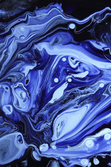 a painting of blue and white swirls on a dark background