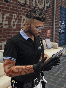 a man with a tattoo on his neck looks at his phone