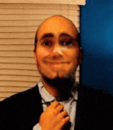 a man in a suit and tie adjusts his tie