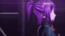 a close up of a person with purple hair standing in a dark room .