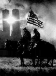 a black and white photo of two men riding horses holding an american flag in front of the twin towers .