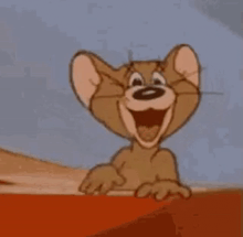 jerry from tom and jerry is laughing and pointing at something .