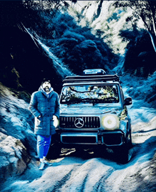 a man is standing in front of a mercedes