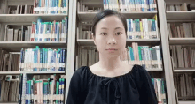 a woman is standing in front of a bookshelf with a book titled ' a brief history of the world '