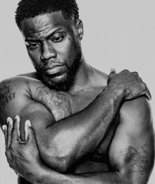 a black and white photo of a shirtless man with a tattoo on his arm that says ' i love you '