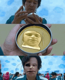 a person is holding a gold coin with a face on it