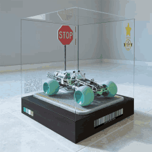 a model of a car with a stop sign in the background